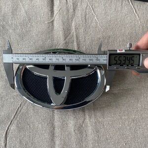 Toyota Corolla Front Grille Emblem 2008–2013, 140 x 95 mm